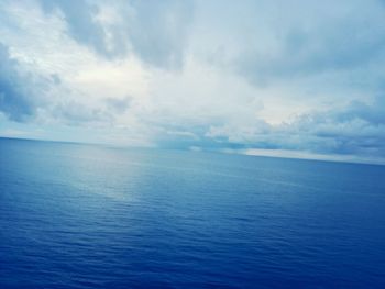 Scenic view of sea against cloudy sky