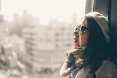 Portrait of young woman looking away during winter