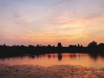 Scenic view of lake against orange sky