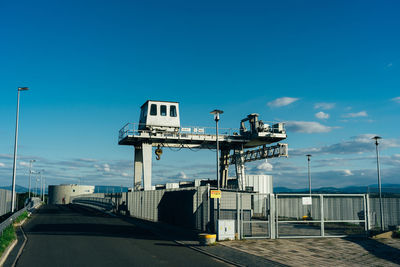 Road by street against blue sky