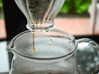 Close-up of coffee pouring in glass