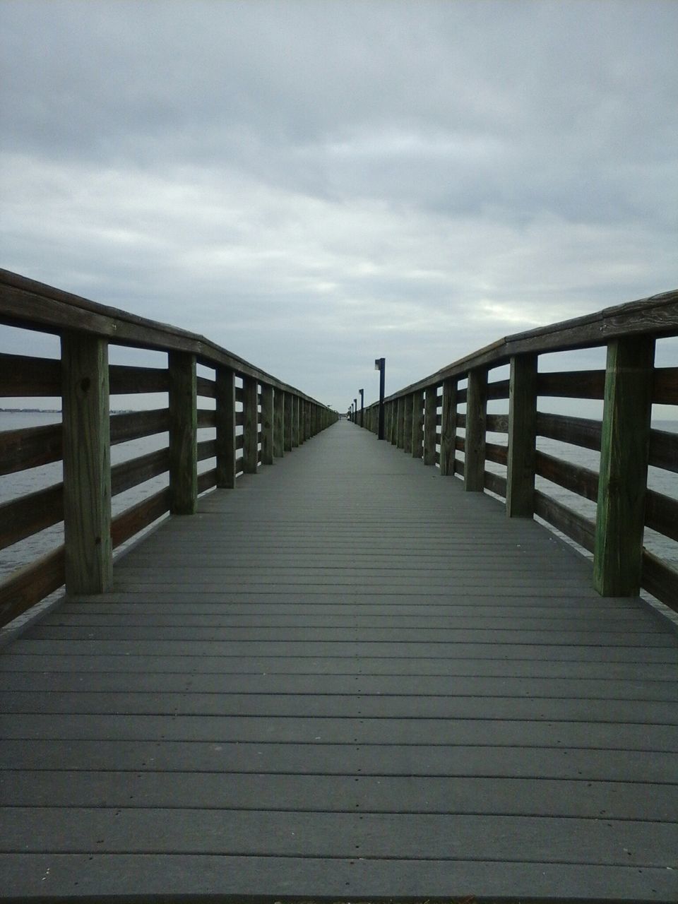 the way forward, sky, railing, pier, diminishing perspective, wood - material, boardwalk, cloud - sky, built structure, water, long, vanishing point, tranquility, cloudy, wood, sea, architecture, cloud, tranquil scene, wooden