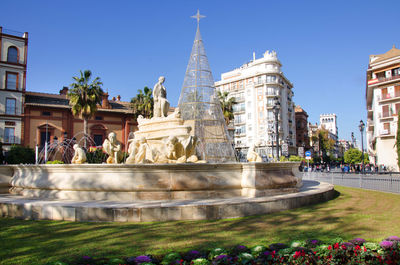 Statue of temple against building