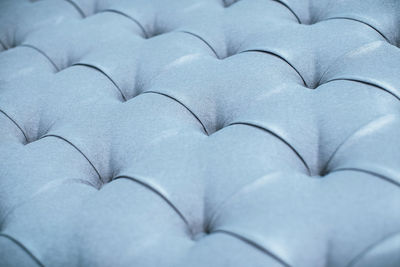 Blue gray upholstered furniture from ement quilted fabric texture. interior design, headboards made