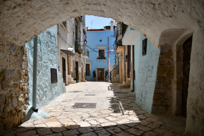 A small street in casamassima, a village with blue-colored houses in the puglia region of italy.