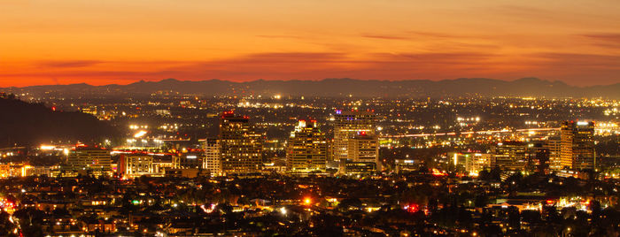 High angle view of city lit up at night