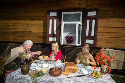 Portrait of friends sitting on table