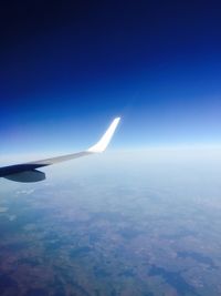 Cropped image of airplane flying over landscape