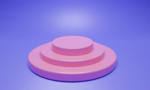 Close-up of pink candle against blue background
