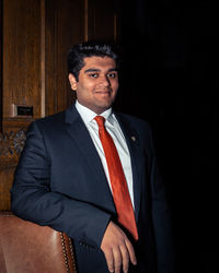 Portrait of young man standing at home