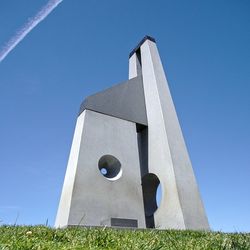 Low angle view of tower against blue sky