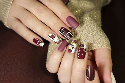 Cropped hands of woman with nail art