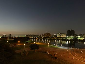 High angle view of illuminated buildings against sky at night