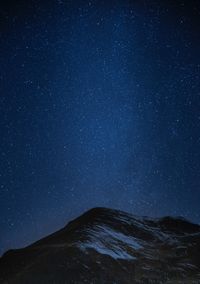 Low angle view of mountain against sky at night