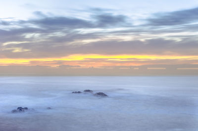 Scenic view of sea at sunset