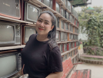 Portrait of smiling young woman standing outdoors