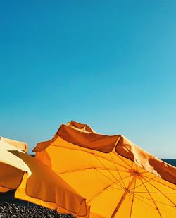 Yellow parasols against clear blue sky