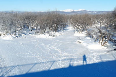 Snow covered landscape against sky