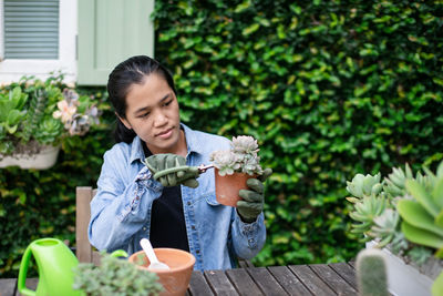 Young woman gardening in backyard