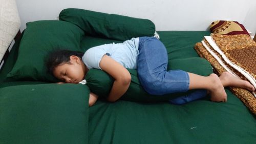 Boy sleeping on bed