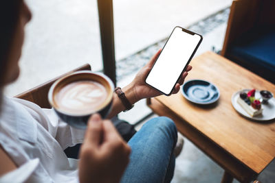 Midsection of woman using mobile phone