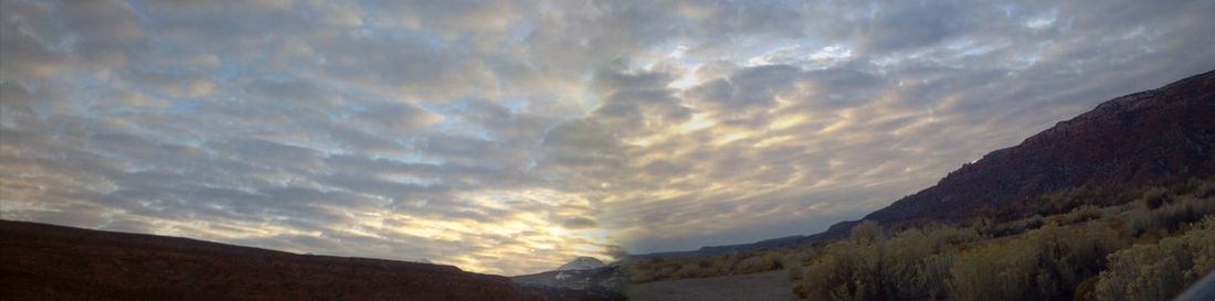 Panoramic view of silhouette mountains against sky during sunset