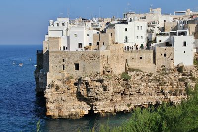 Large cliff on the seashore, rocks by the sea, buildings built on the rocks, polignano a mare