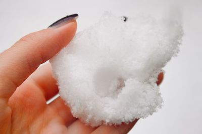Close-up of hand holding white background