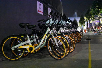 Bicycle parked on street at night