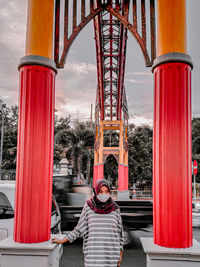 Rear view of people at amusement park against sky
