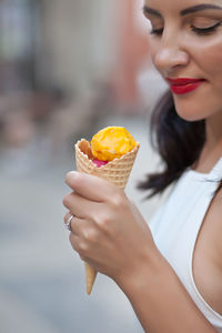 Midsection of woman holding ice cream