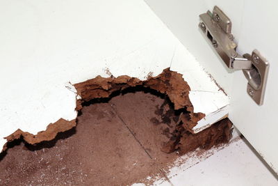 High angle view of broken glass on table against wall