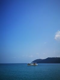 Sailboat sailing on sea against sky