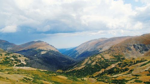 Scenic view of mountains against cloudy sky