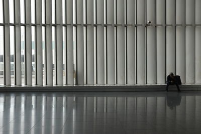 Rear view of man and woman walking on floor