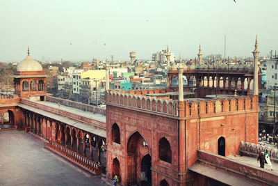 Jama masjid by cityscape against clear sky