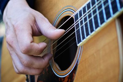 Close-up of man playing guitar