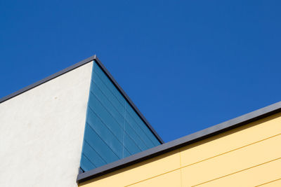 Low angle view of building against clear blue sky