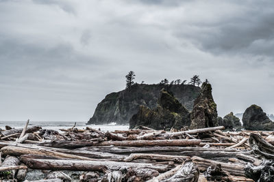Stack of rocks on sea against sky