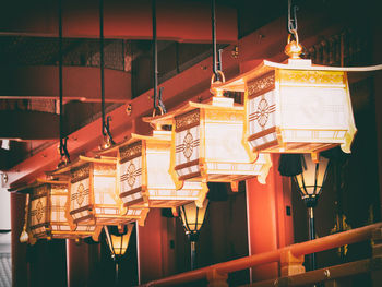 Illuminated lanterns hanging on ceiling of building