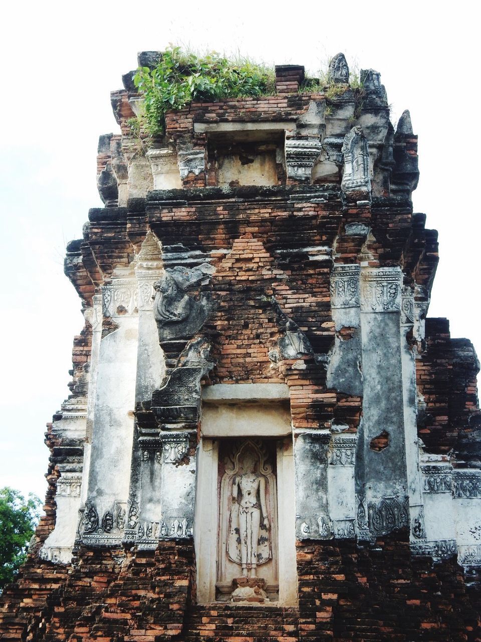 human representation, religion, sculpture, statue, spirituality, low angle view, architecture, place of worship, built structure, history, no people, day, old ruin, building exterior, travel destinations, outdoors, ancient civilization, sky