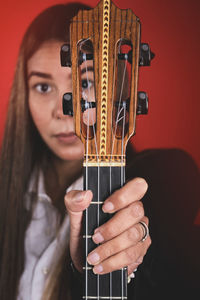 Beautiful young woman playing a cuatro, typical venezuelan instrument. recording session