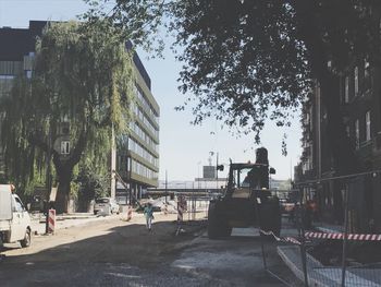 Man on street in city against clear sky