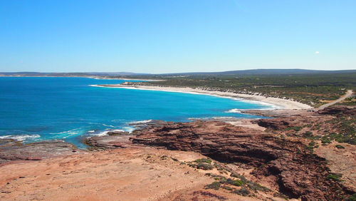 Scenic view of beach against blue sky