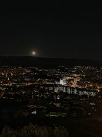 High angle view of illuminated city against sky at night