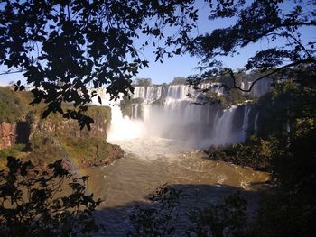 Scenic view of waterfall against sky