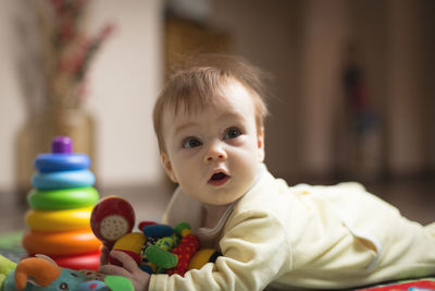 Portrait of cute boy with toy at home