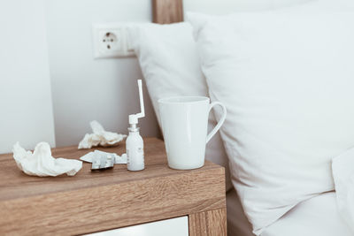 Low section of man relaxing on bed at home