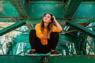 Woman has fun exploring an old, abandoned iron railroad bridge