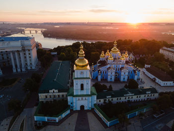 High angle view of buildings in city at sunset